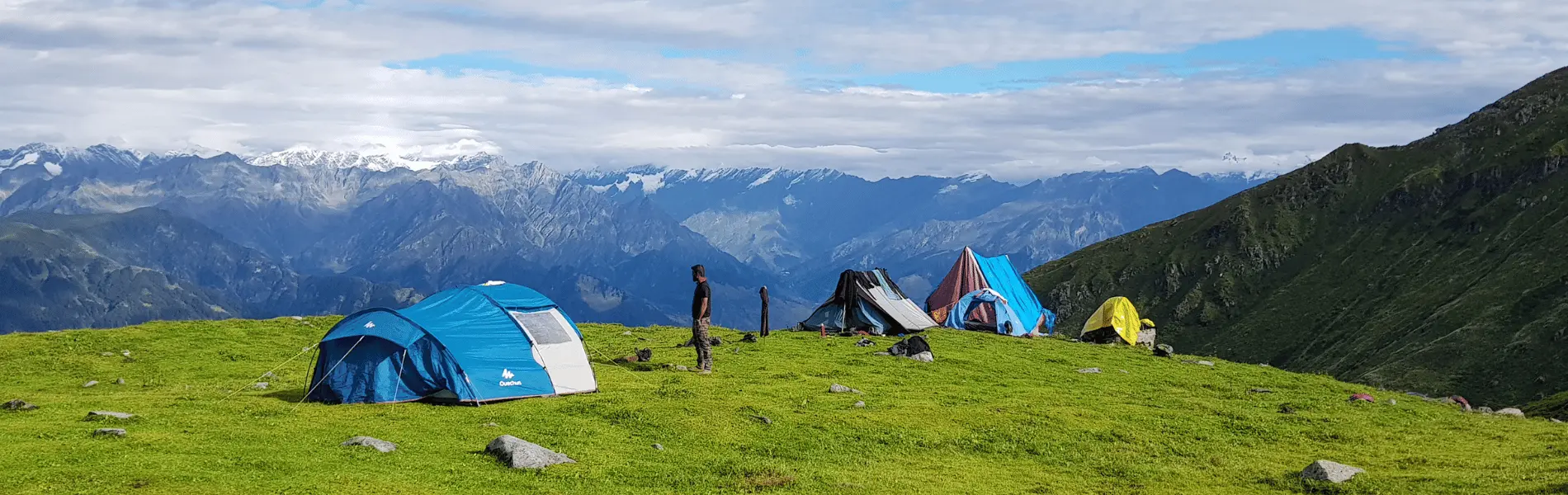 tents piched on meadow on the mountain of the broken lake trek with YoloO Life