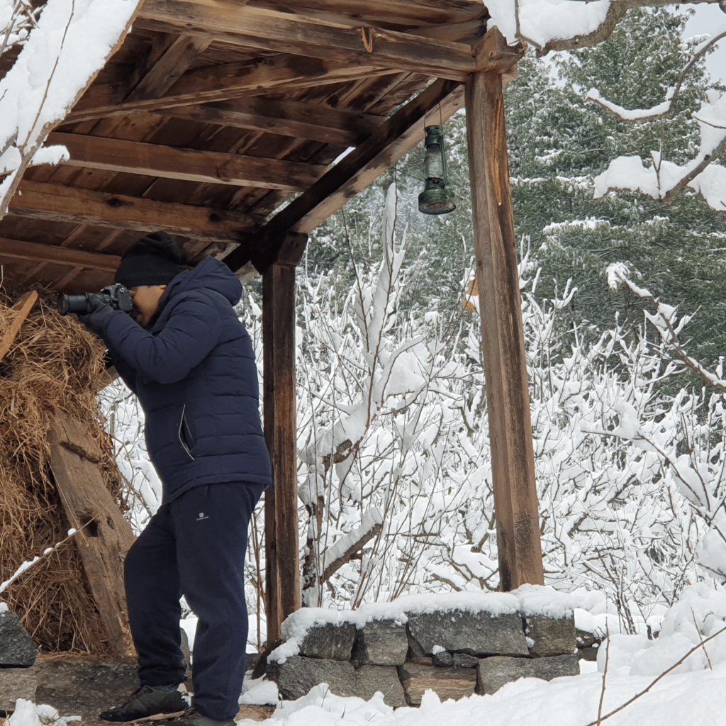 a photographer in remote village house in manali