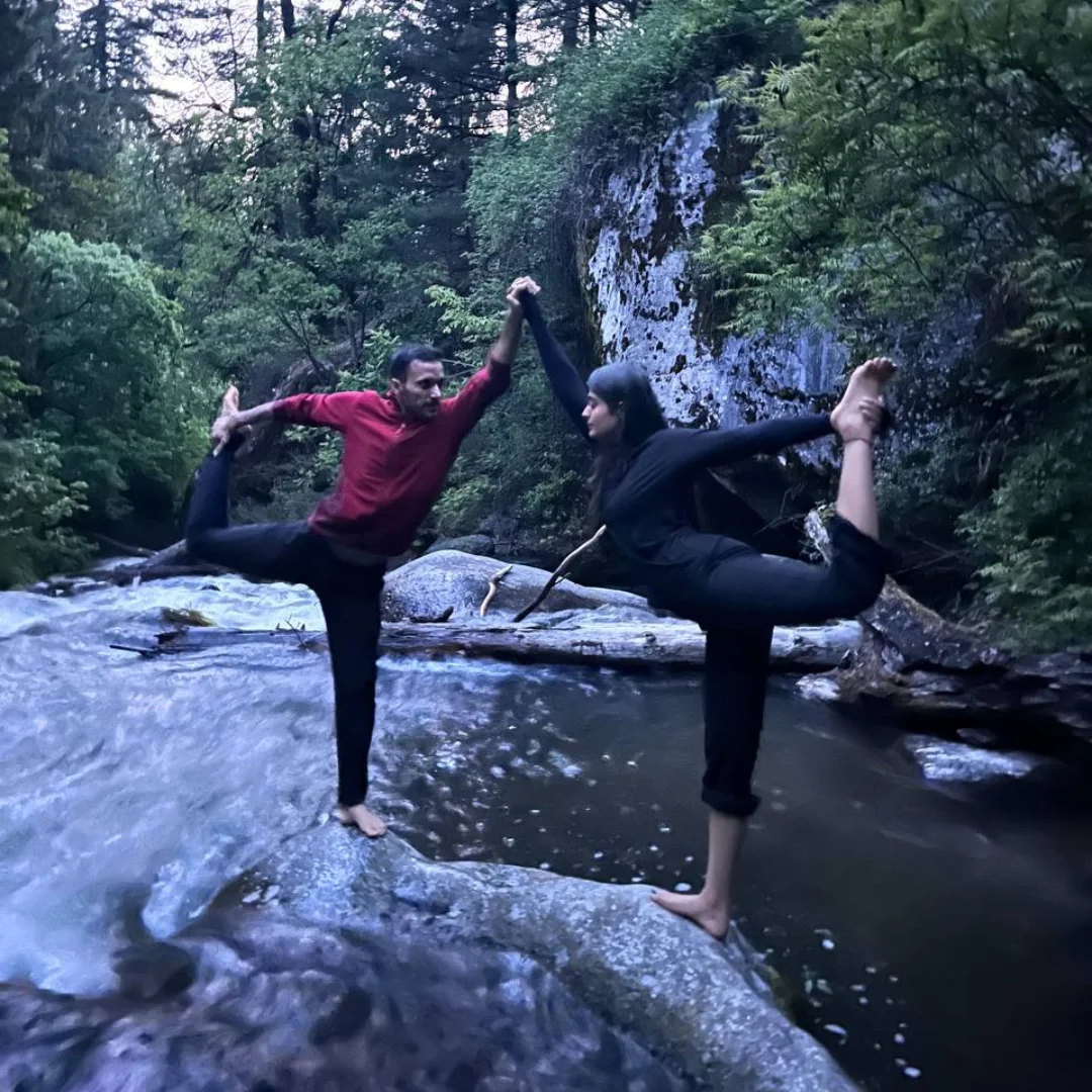 nature and wellbeing homepage people doing yoga by a stream at 'the vanvaas lodge' in Soil village near Manali