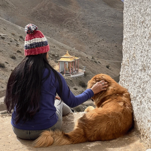 girl sitting with a dog on Spiti Valley Tour