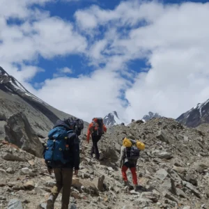 parangla trek, trekking in the himalayas with yoloO life 3 hikers with backpacks on the parangla trek with yoloO life