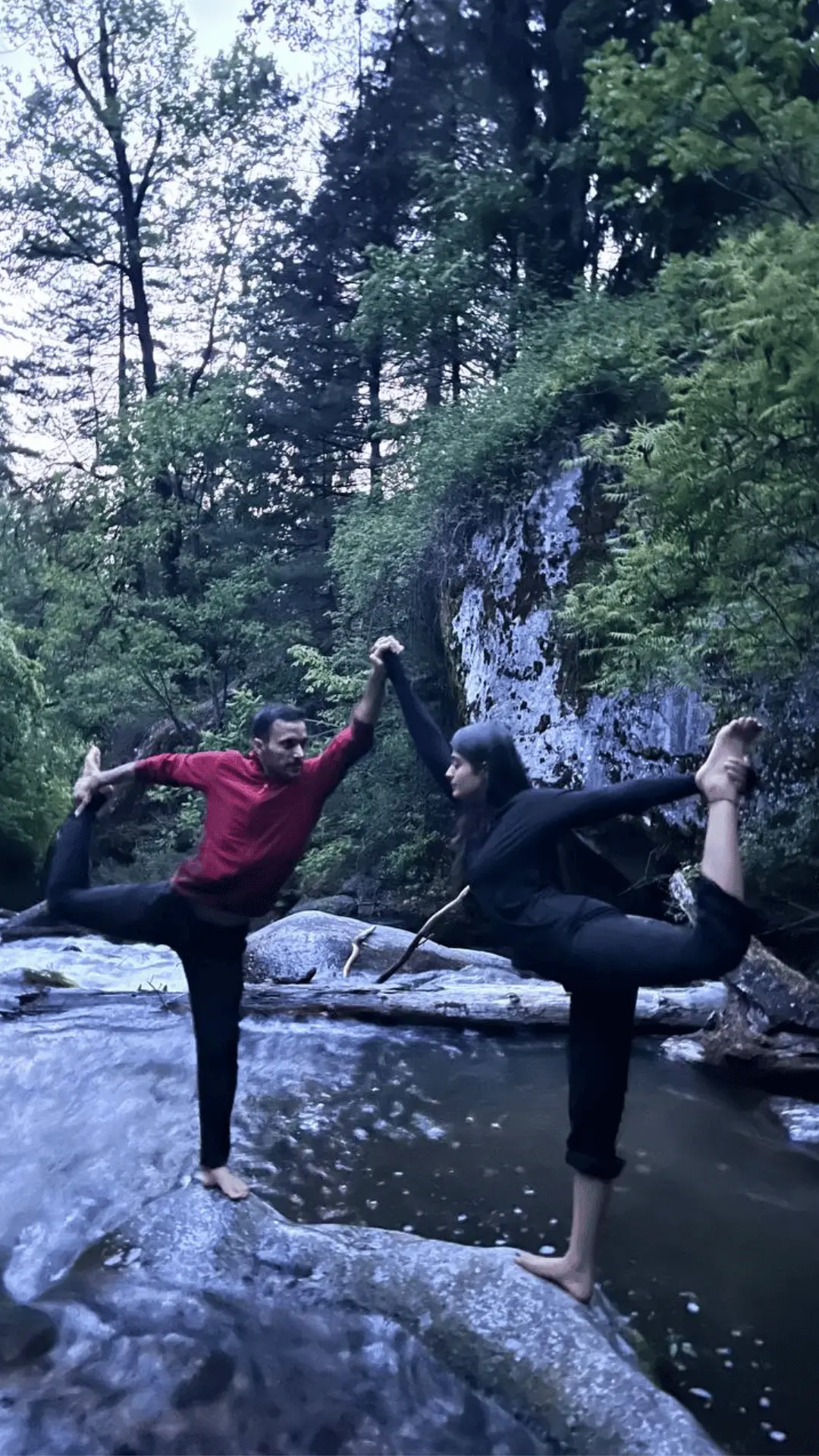 couple doing yoga next to a stream at VanVaas in Soil or SoyalVillage, Manali