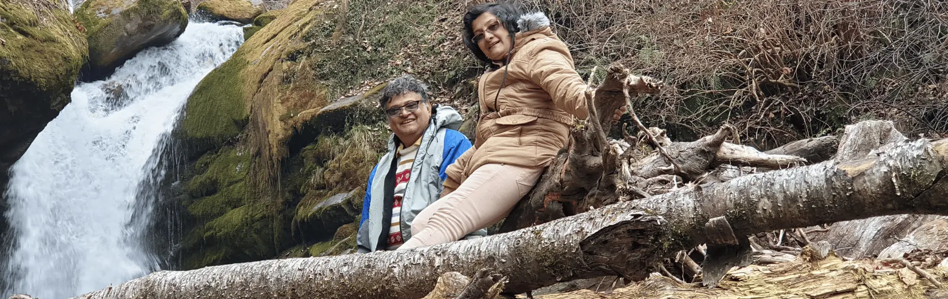 couple in front of a waterfall